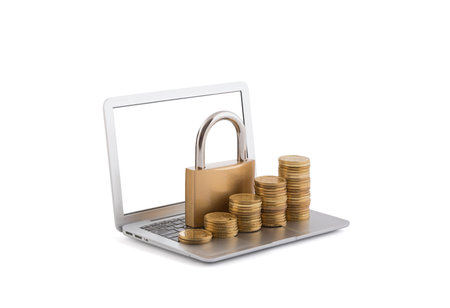 Rising coins with padlock on laptop isolated on white backgroundの写真素材