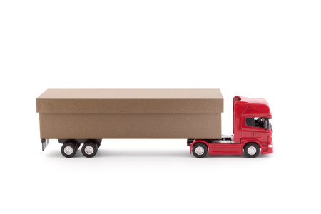 Long delivery truck with a cardboard box trailer isolated on white backgroundの写真素材