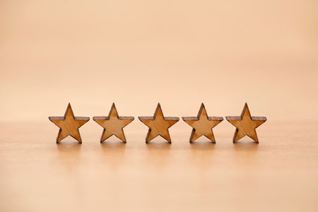 Five wooden stars on wooden background