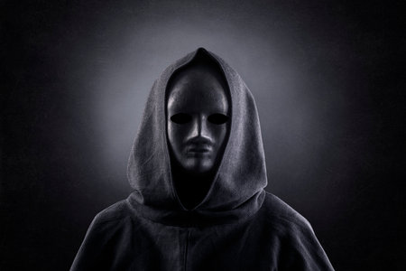Portrait of a scary figure in hooded cloakの写真素材