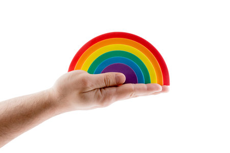 Colorful rainbow in hand isolated on white background with clipping path. LGBTQ + related symbol.の写真素材