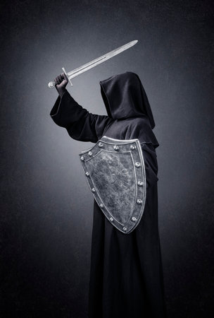 Dark knight with sword and shield in the darkの写真素材