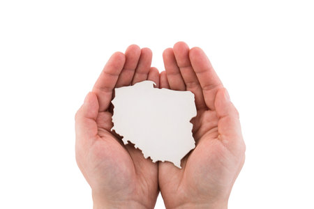 Shape of Poland map in hands isolated on white background with clipping pathの写真素材