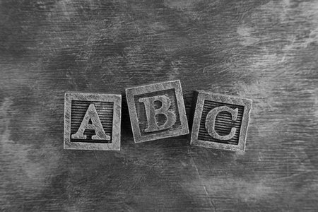 Vintage wooden alphabet blocks on dark wooden backgroundの写真素材