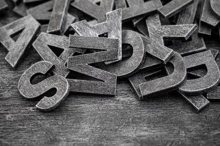 Pile of old vintage wooden letters. Typography background composition.の写真素材