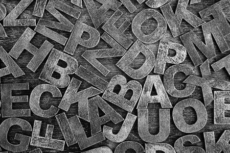 Pile of old vintage wooden letters. Typography background composition.の写真素材