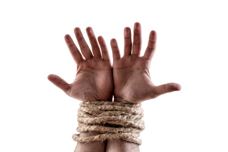 Two hands tied with a rope isolated on white background with clipping pathの写真素材