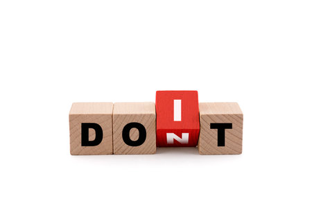 Wooden blocks with the words Don't or Do it on white with clipping pathの写真素材