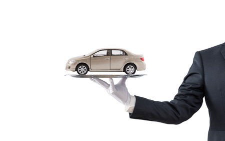 Businessman offering golden car on silver tray