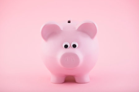 Pink piggy bank on pink backgroundの写真素材