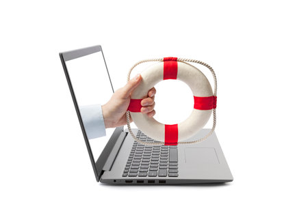 Hand holding a lifebuoy out of a laptop screen isolated on whiteの写真素材