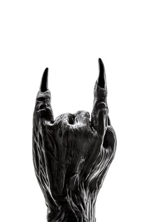 Creepy monster hand showing rock or devil horns gesture isolated on white with clipping pathの写真素材