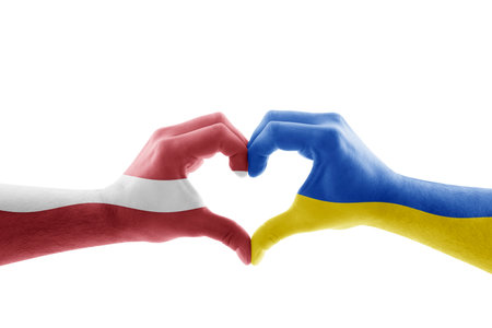 Two hands in the form of heart with Latvian and Ukrainian flag isolated on white backgroundの写真素材