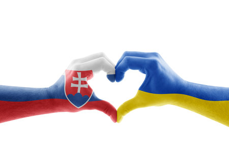 Two hands in the form of heart with Slovak and Ukrainian flag isolated on white backgroundの写真素材