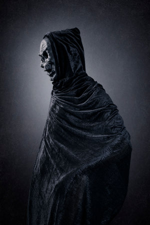 Grim reaper over dark misty backgroundの写真素材