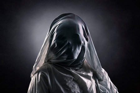 Portrait of a scary ghost over dark misty backgroundの写真素材