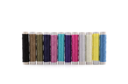 Colorful thread spools on white background with clipping pathの写真素材