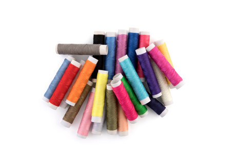 Colorful thread spools on white background with clipping path