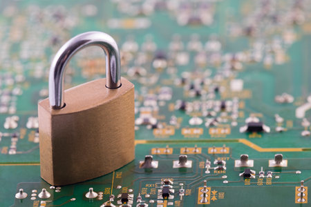 Computer security concept. Padlock on green computer circuit boardの写真素材