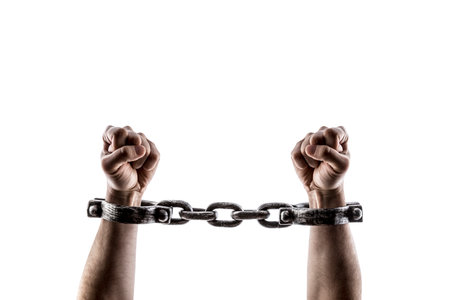 Shackled hands isolated on white background with clipping pathの写真素材
