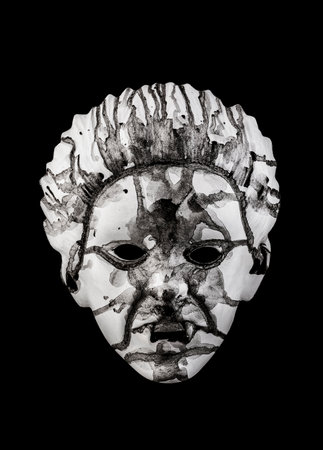 Scary white head painted black isolated on black backgroundの写真素材