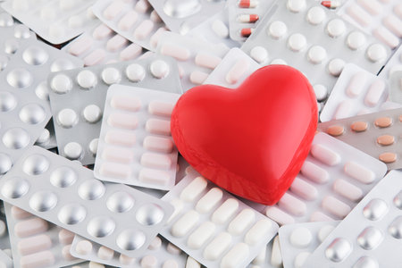 Red heart on big heap of many various pills and tablets packsの写真素材