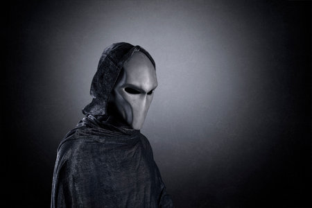 Mysterious humanoid alien at night over dark misty backgroundの写真素材