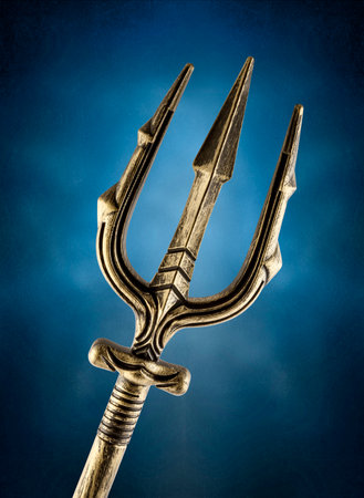 Golden trident over blue misty backgroundの写真素材