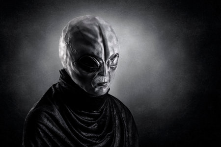 Mysterious humanoid alien at night over dark misty background