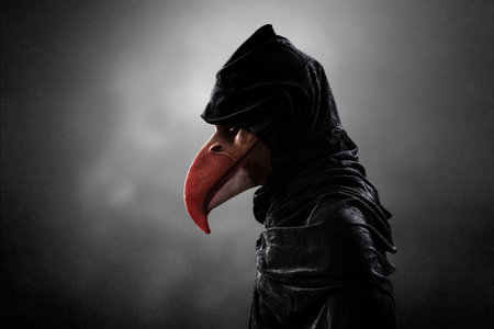 Creepy figure with long bird beak in hooded cloak over dark misty background