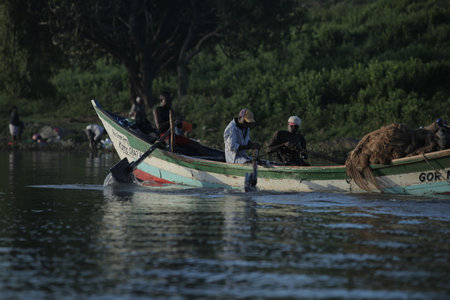 KENYA, KISUMU - MAY 20, 2017: African men sitting in the boat. Males working, fishing. Business of local people in Africa.のeditorial素材