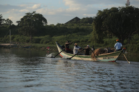 KENYA, KISUMU - MAY 20, 2017: African men sitting in the boat. Males working, fishing. Business of local people in Africa.のeditorial素材