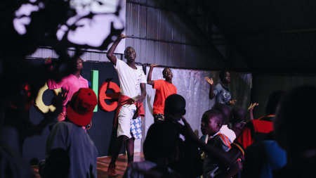 KENYA, KISUMU - MAY 20, 2017: Big group of African children dancing inside together, listen music and singing.のeditorial素材