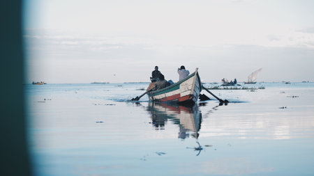 KENYA, KISUMU - MAY 20, 2017: African men sitting in the boat. Males working, fishing. Business of local people in Africa.のeditorial素材