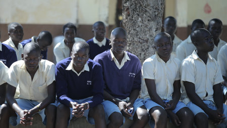 KENYA, KISUMU - MAY 20, 2017: Group of african children sitting on ground. Boys and girls in uniform spend time outside.のeditorial素材
