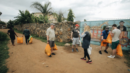 KENYA, KISUMU - MAY 20, 2017: Group of Caucasian people with packages. The volunteers traveled to Africa to help the poor families.のeditorial素材