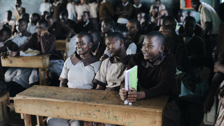 KENYA, KISUMU - MAY 20, 2017: Group of happy African children sitting in classroom and smiling, laughing together.のeditorial素材