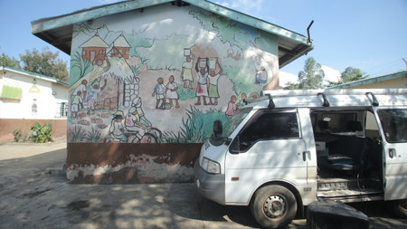 KENYA, KISUMU - MAY 23, 2017: Camera shoots the wall of the African house. Beautiful colored ethnic pictures on the wall.のeditorial素材