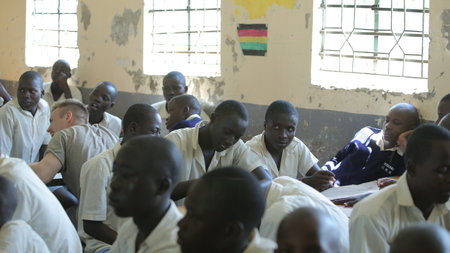 KENYA, KISUMU - MAY 23, 2017: Close-up view of three african boys in uniform sitting in classroom in schoolのeditorial素材