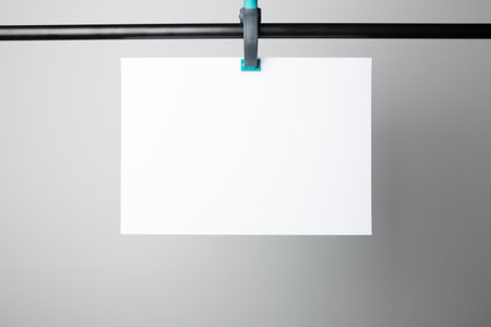 Blank poster hanging on A Clamp, ready to replace your design.