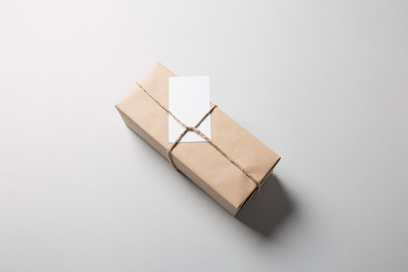 Package with rope and greeting card on gray backgroundの写真素材