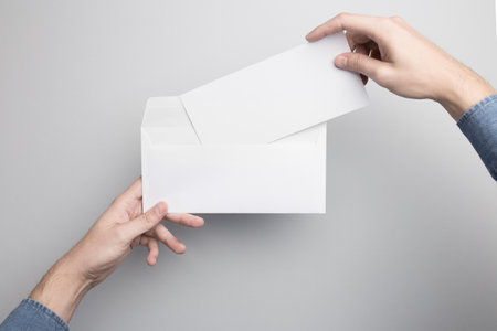 Hand holding Blank Envelope Mock-up, ready to replace your design.の写真素材