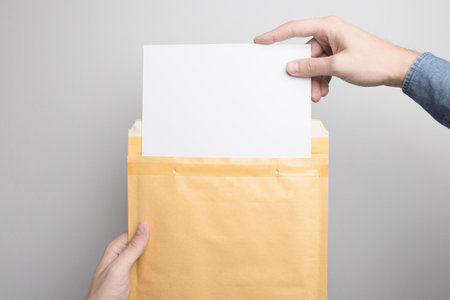 Hand holding Blank padded Envelope Mock-up, ready to replace your design.