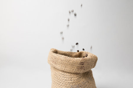 Coffee sack with beans falling downの写真素材