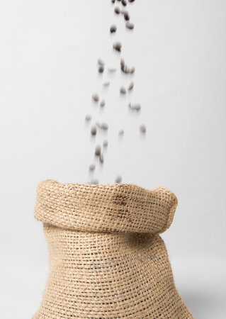 Coffee sack with beans falling downの写真素材