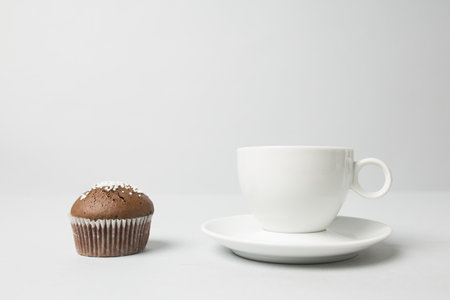 Coffee cup with a muffinの写真素材