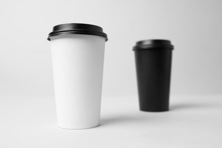 Black and white paper cup with a black capmockupの写真素材