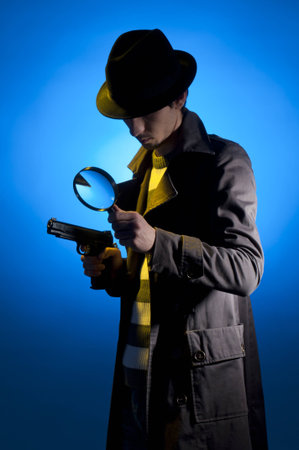 Private detective searching for information, isolated on a blue backgroundの写真素材
