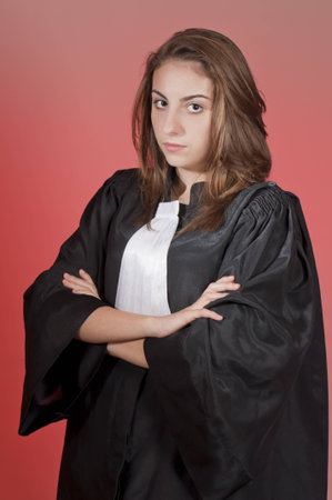 Serious young law school student, isolated on redの写真素材
