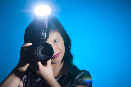 Attractive young photographer holding her camera
